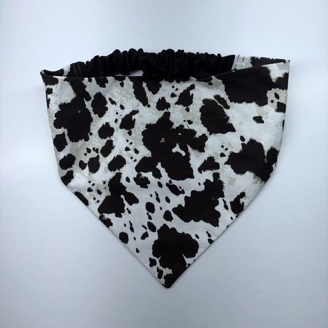 Scrunchie Bandana sewn in black and white cow print fabric on a white background