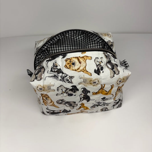 Colorful dog patterned quilted bag on a white background