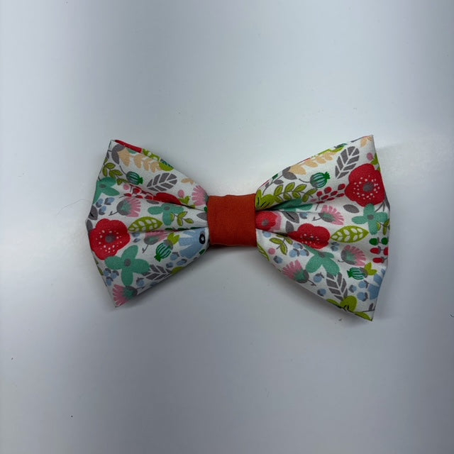 Floral patterned bow tie with red center on a white background