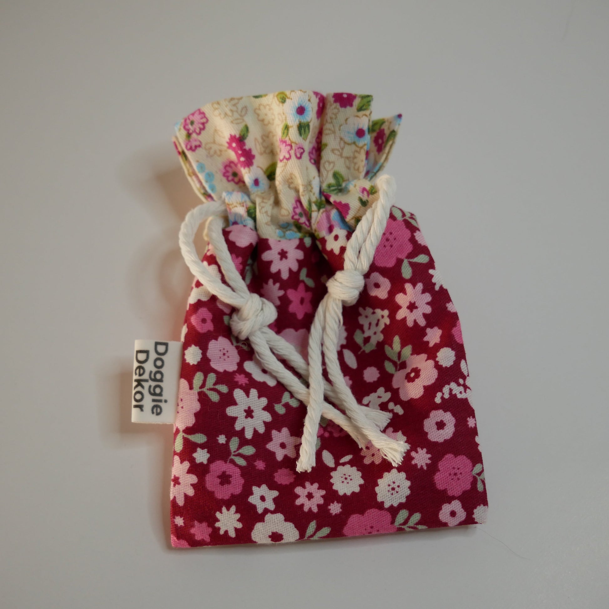 Dog poo bag holder - 100% cotton drawstring pouch in dark pink with a pink floral pattern and a cream floral collar, white drawstring and metal clip - Doggie Dekor