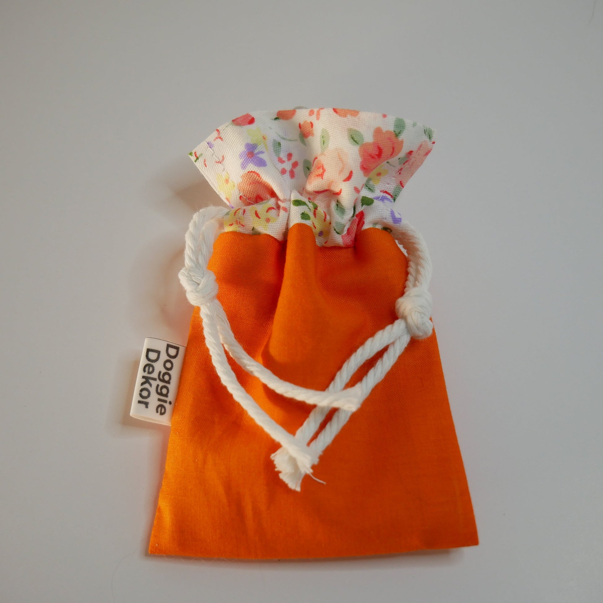 Dog poo bag holder - 100% cotton drawstring pouch in bright orange with a cream floral collar, white drawstring and metal clip - Doggie Dekor