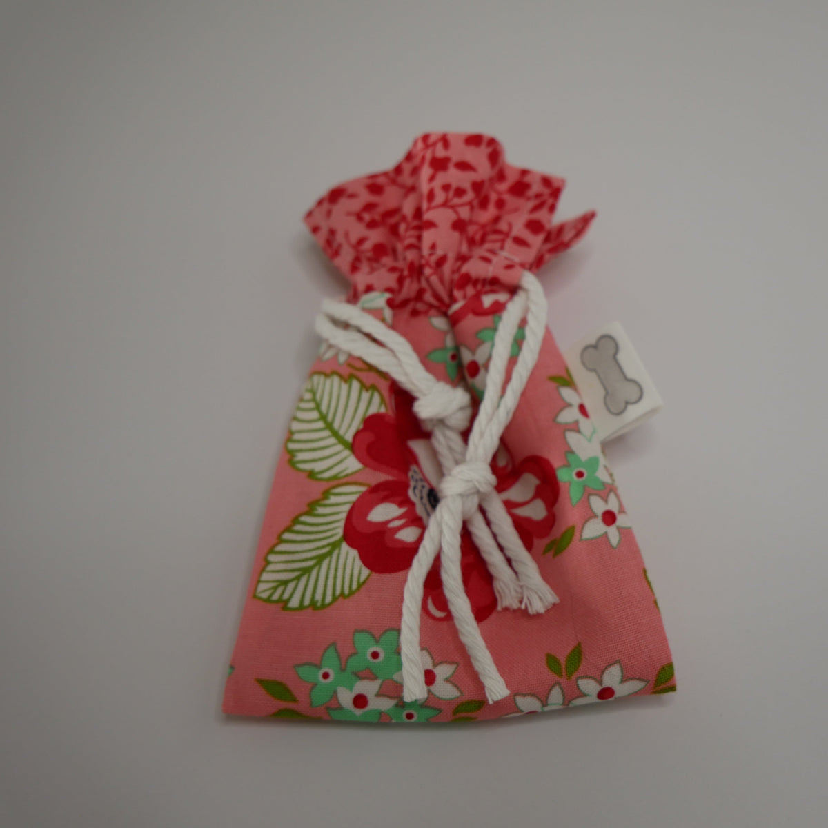 Dog poo bag roll holder in salmon floral  bottom and salmon and red collar - Doggie Dekor