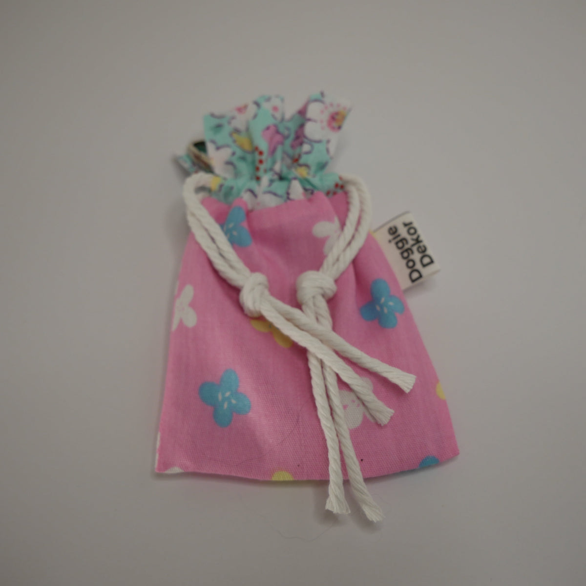 Dog poo bag roll holder in light pink with a blue floral collar - Doggie Dekor