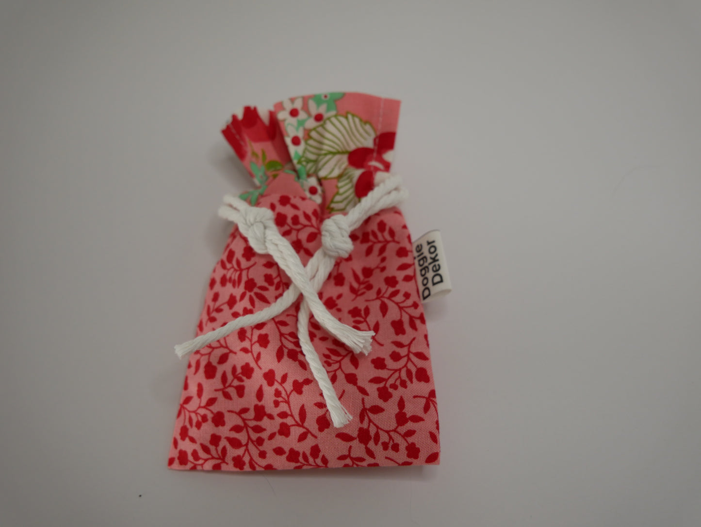 Dog poo bag roll holder in coral with a coral floral collar - Doggie Dekor