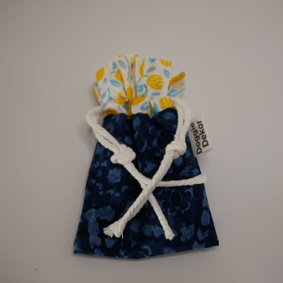 Dog poo bag roll holder in dark printed blue bottom and white with lemons on the white collar - Doggie Dekor