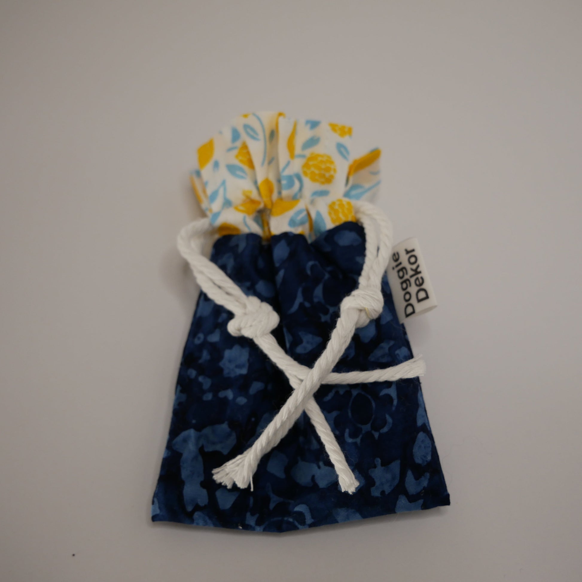 Dog poo bag roll holder in dark printed blue bottom and white with lemons on the white collar - Doggie Dekor