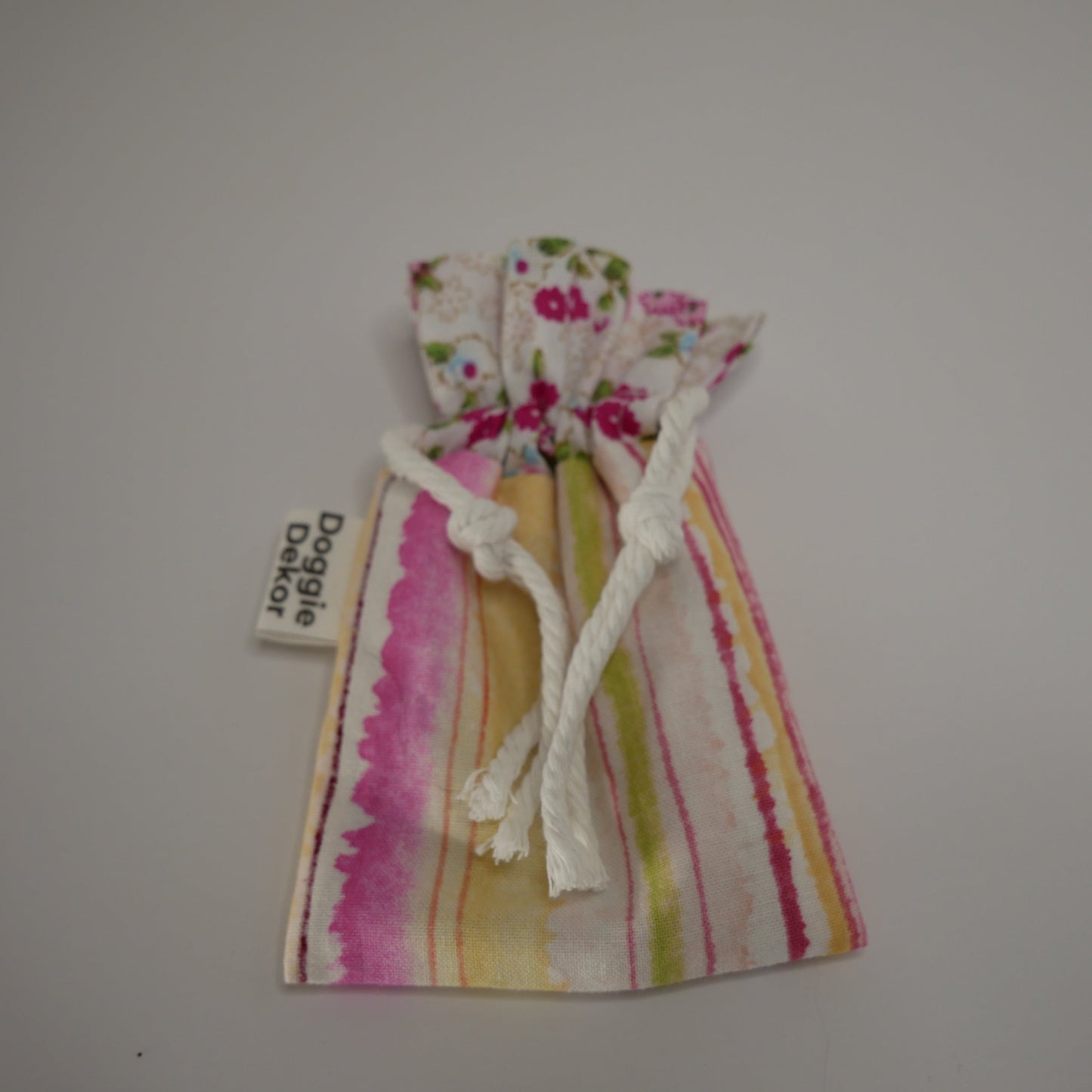 Dog poo bag roll holder in pink toned striped bottom and floral white collar - Doggie Dekor