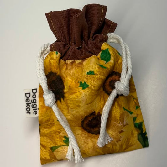 the POOO Pouch  - A small drawstring pouch with a yellow sunflower print, brown ruffle collar that holds a roll of dog poo bags - Doggie Dekor - Calgary