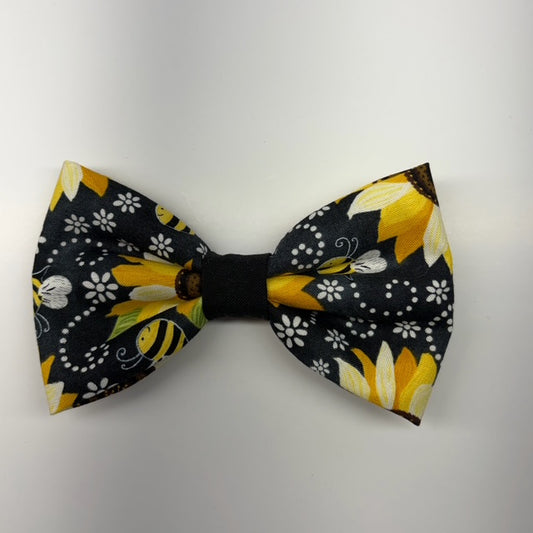Bow tie with yellow and black floral pattern on a white background