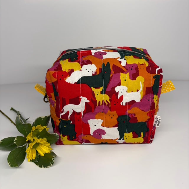 Colorful dog patterned quilted bag on a white background