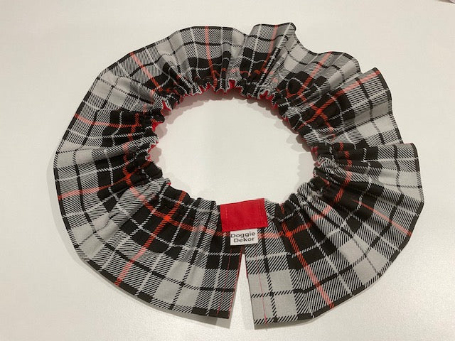 A black, white, and red plaid dog neck ruffle by Doggie Dekor, Calgary