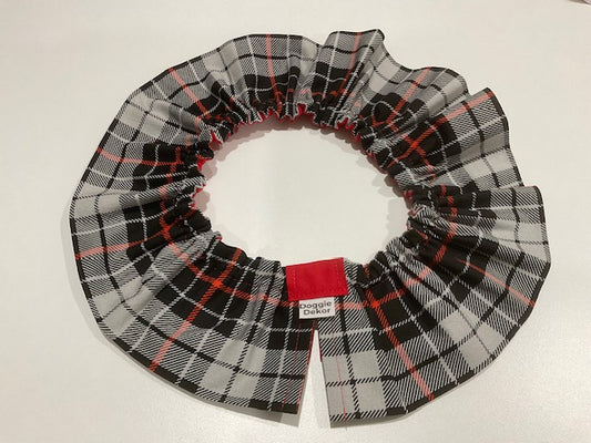 A black, white, and red plaid dog neck ruffle by Doggie Dekor, Calgary