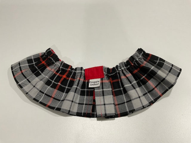 A black, white, and red plaid dog neck ruffle by Doggie Dekor, Calgary