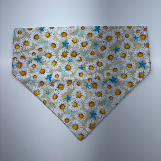Floral patterned scrunchie bandana with daisies and blue starfish on a plain background